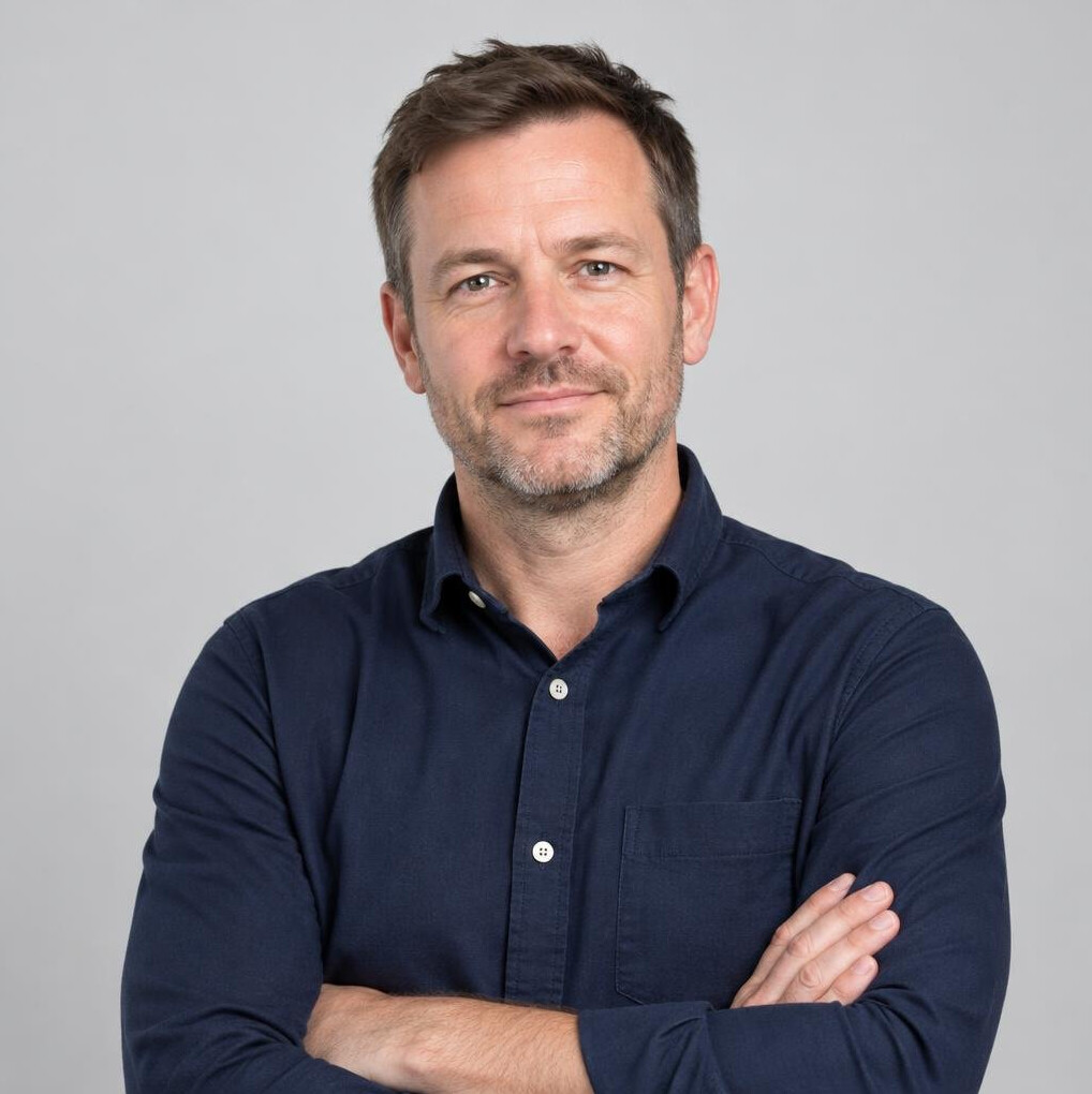 Portrait of a man in a navy shirt in a studio