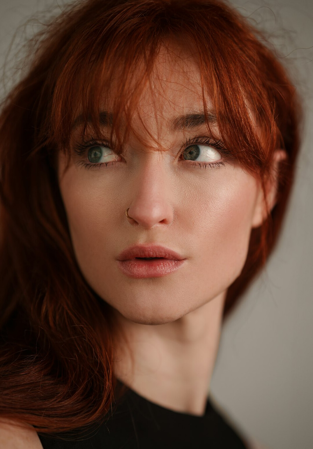 Portrait of a woman with red hair in a studio